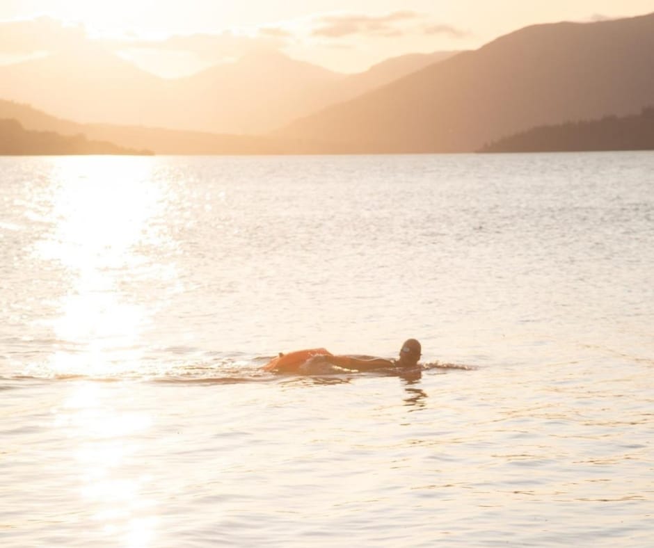 swimmer in the sea at sunset