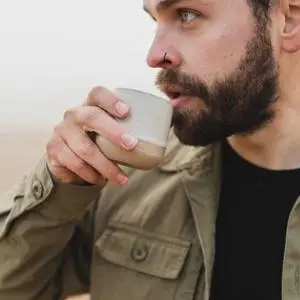 man drinking from mug